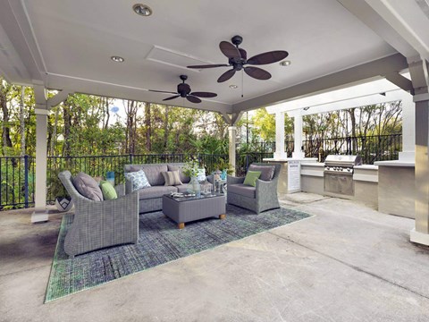 A patio with furniture and a ceiling fan.