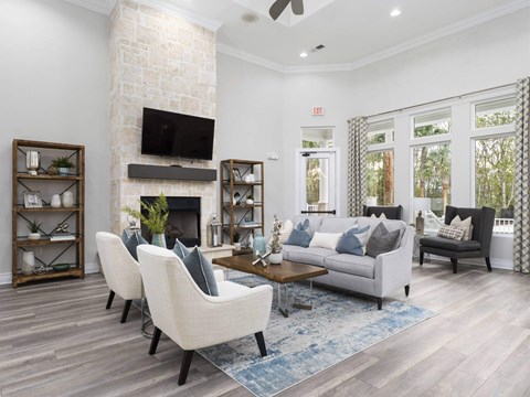A living room with a fireplace and a flat screen TV mounted above it.