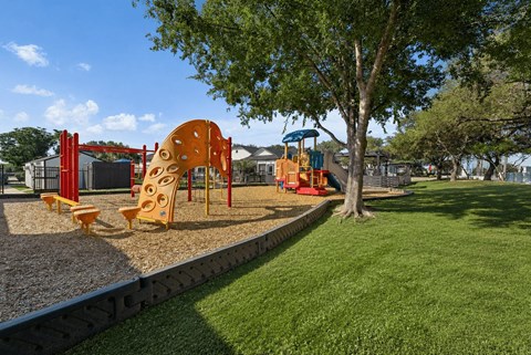 A playground with a slide, swings, and a climbing structure.