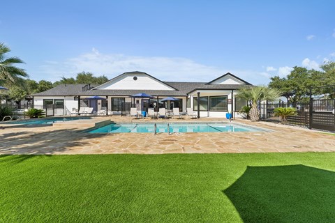 A large house with a pool in the backyard.