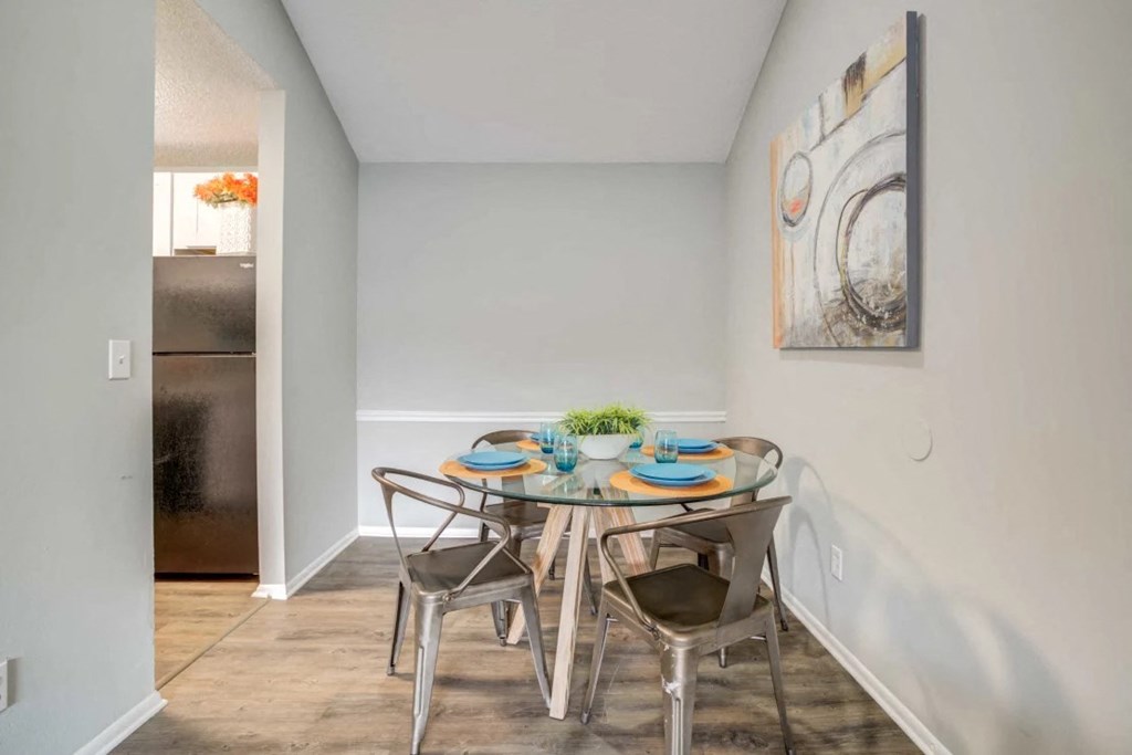 a dining room with a table and chairs