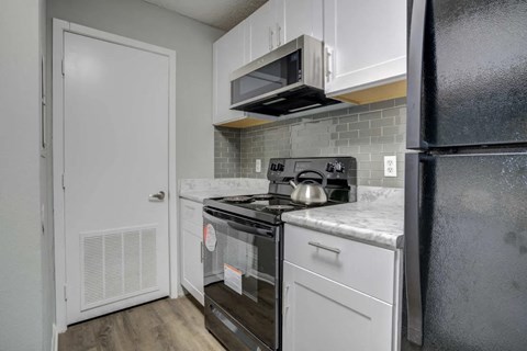 a kitchen with a stove microwave and refrigerator