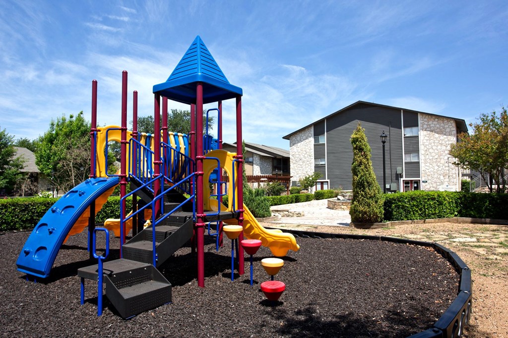 a playground at a school with a building in the background
