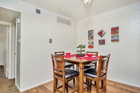 A dining room with a table set for two.