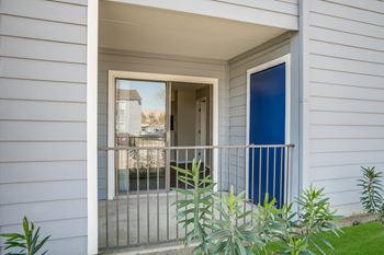 A white house with a blue door and a window.