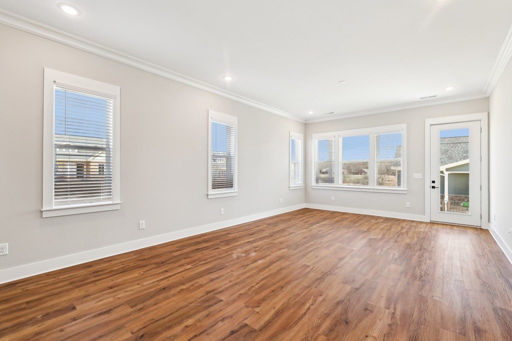 A room with wooden floors and white walls.