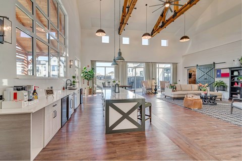 A modern kitchen with white cabinets and a wooden island.