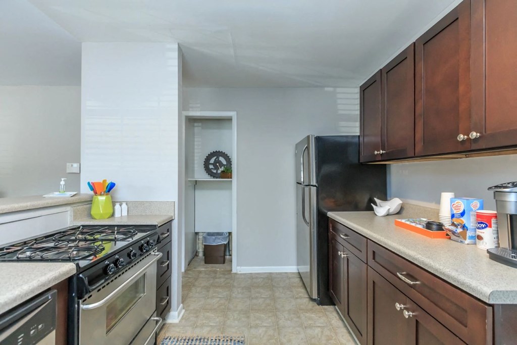 a kitchen with wood cabinets and stainless steel appliances