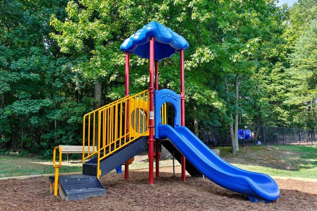 a playground with a blue and red slide