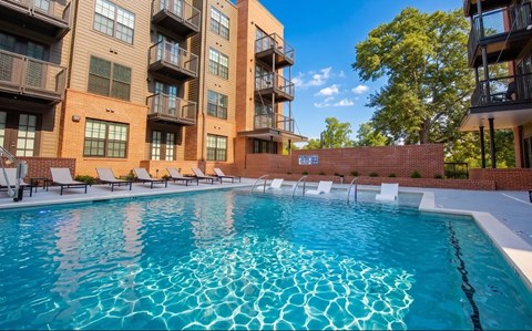 A swimming pool in front of apartment buildings.