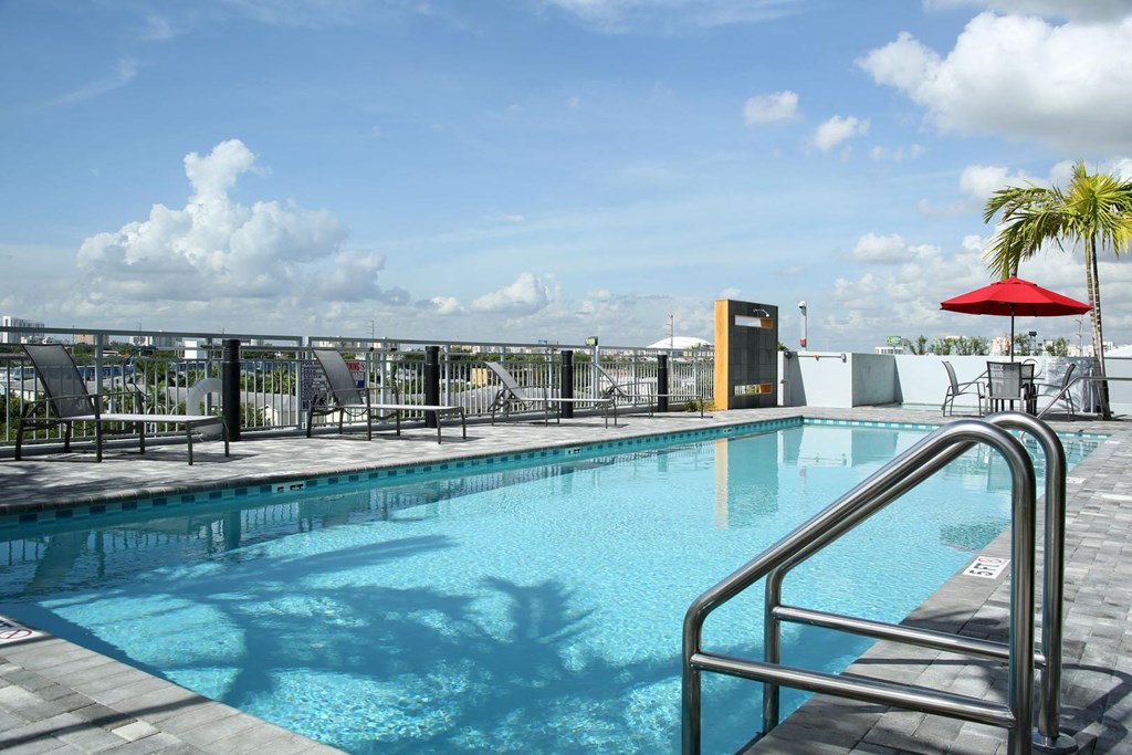 a swimming pool with a blue sky in the background
