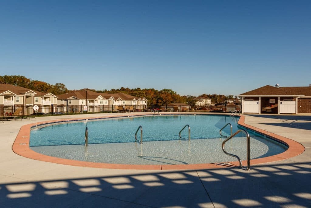 a swimming pool with apartments in the background