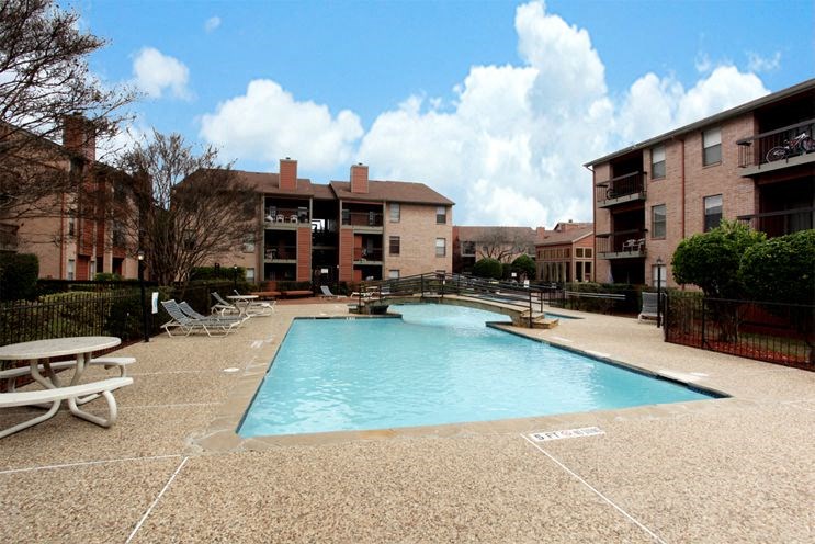 a swimming pool in front of a apartment building