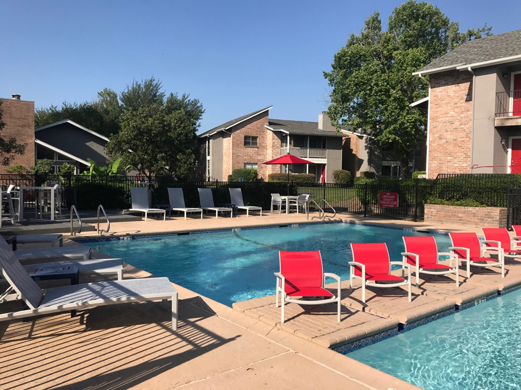 side of pool area with lounge chairs
