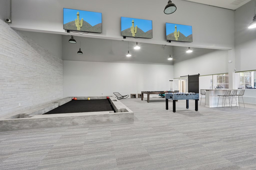 a games room with a pool table foosball table and ping pong table