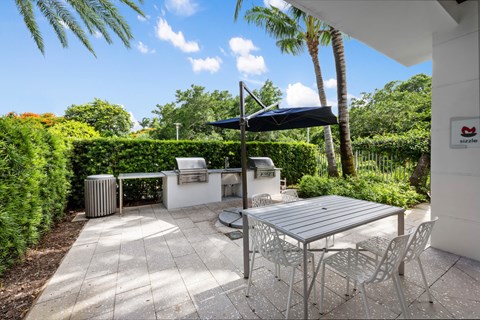 a patio with a table and chairs and an umbrella