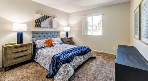A bedroom with a large bed and a dresser.