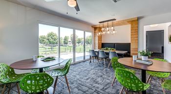 A room with a table and chairs and a television.