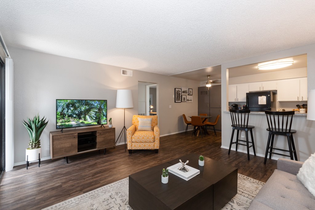 A living room with a television and a yellow chair.