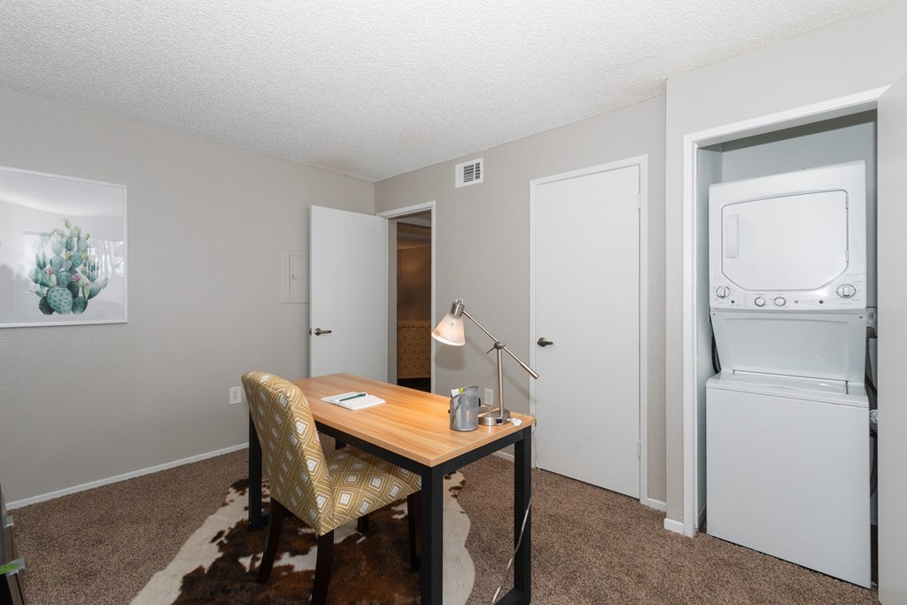 A small room with a desk and a chair.