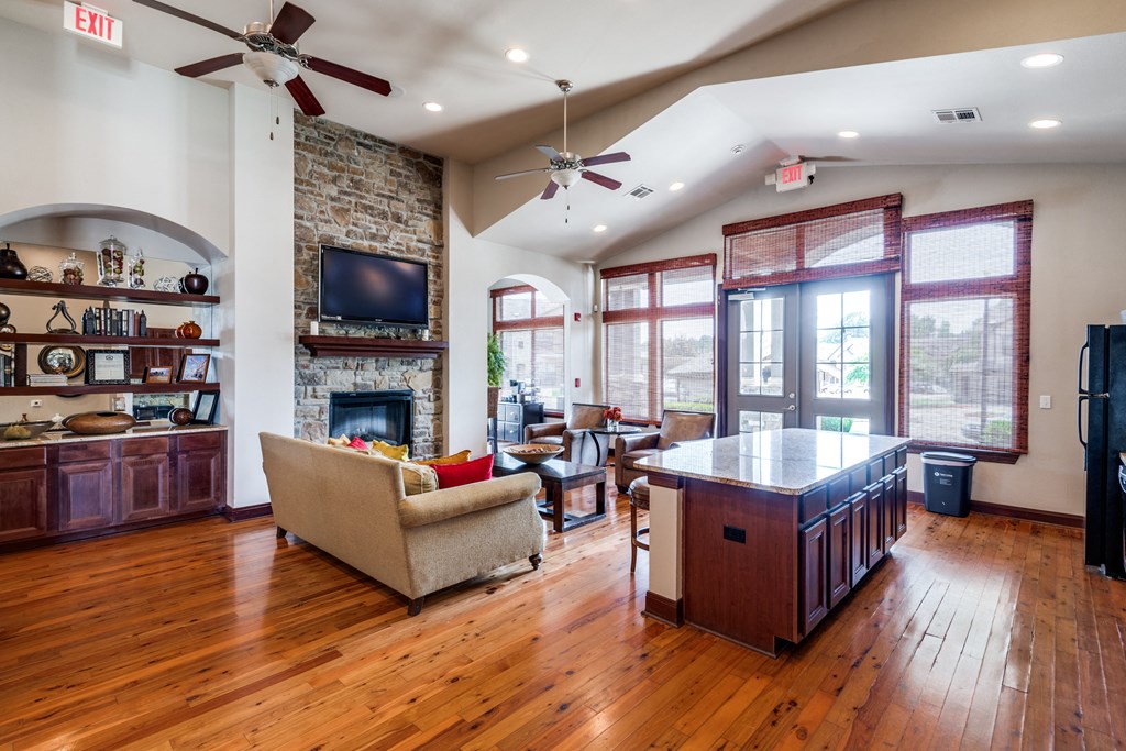 a living room with a fireplace and a kitchen