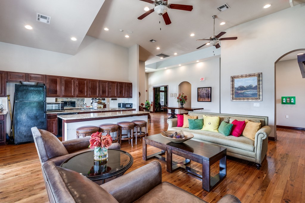 a living room with a kitchen and a couch and a table