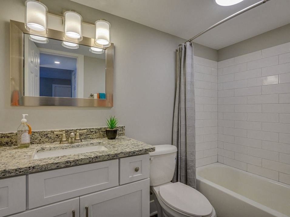 a bathroom with a sink toilet and a shower