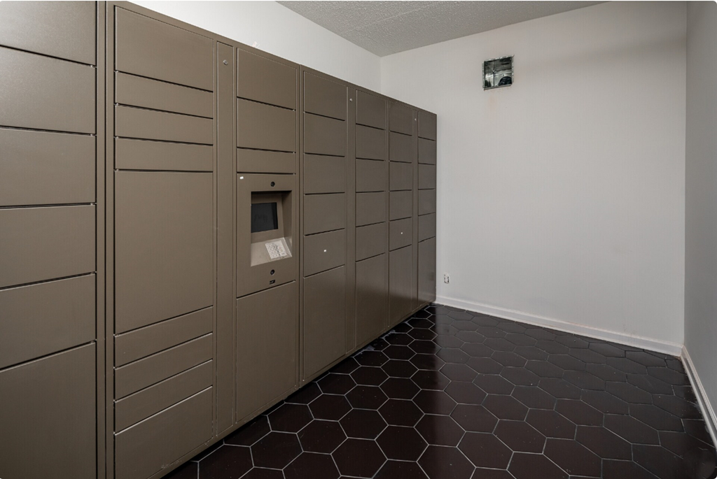 a lockers in a room with a black tiled floor