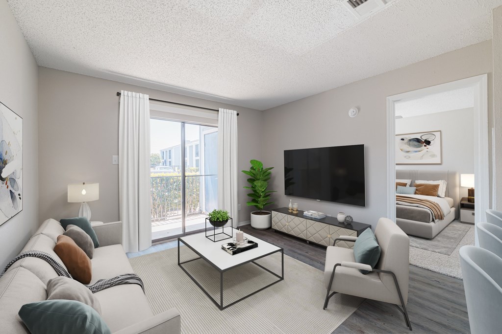 A modern living room with a white sofa, a glass coffee table, and a television.