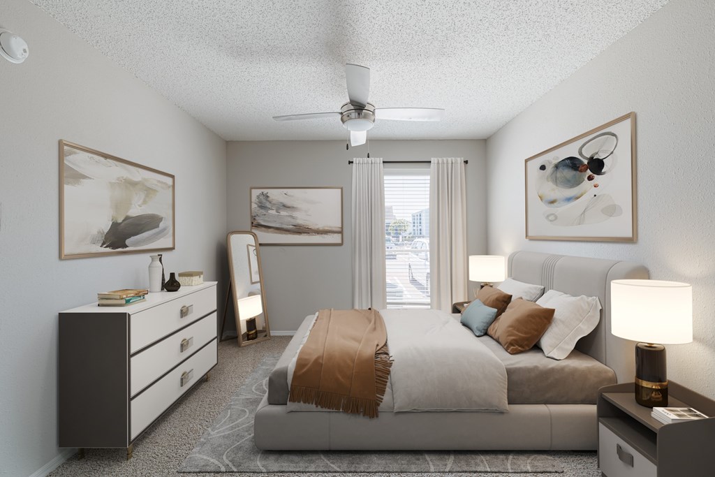 A bedroom with a bed, dresser, and ceiling fan.