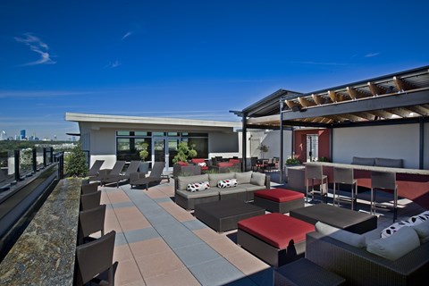 A modern outdoor seating area with a view of the city.