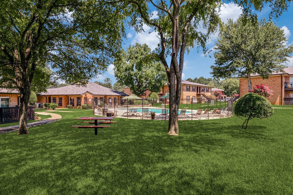 a backyard with a picnic table and a pool