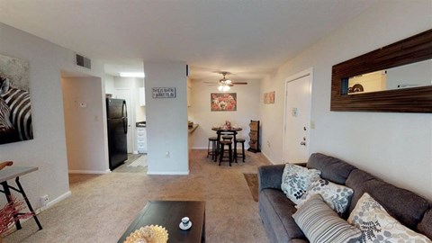 a living room and dining room with a couch and a table