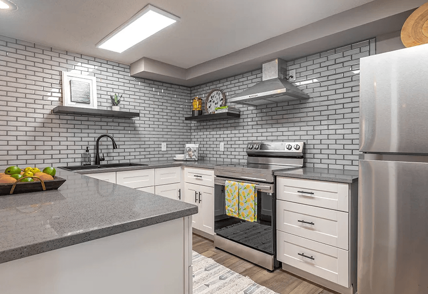 a kitchen with white cabinets and stainless steel appliances