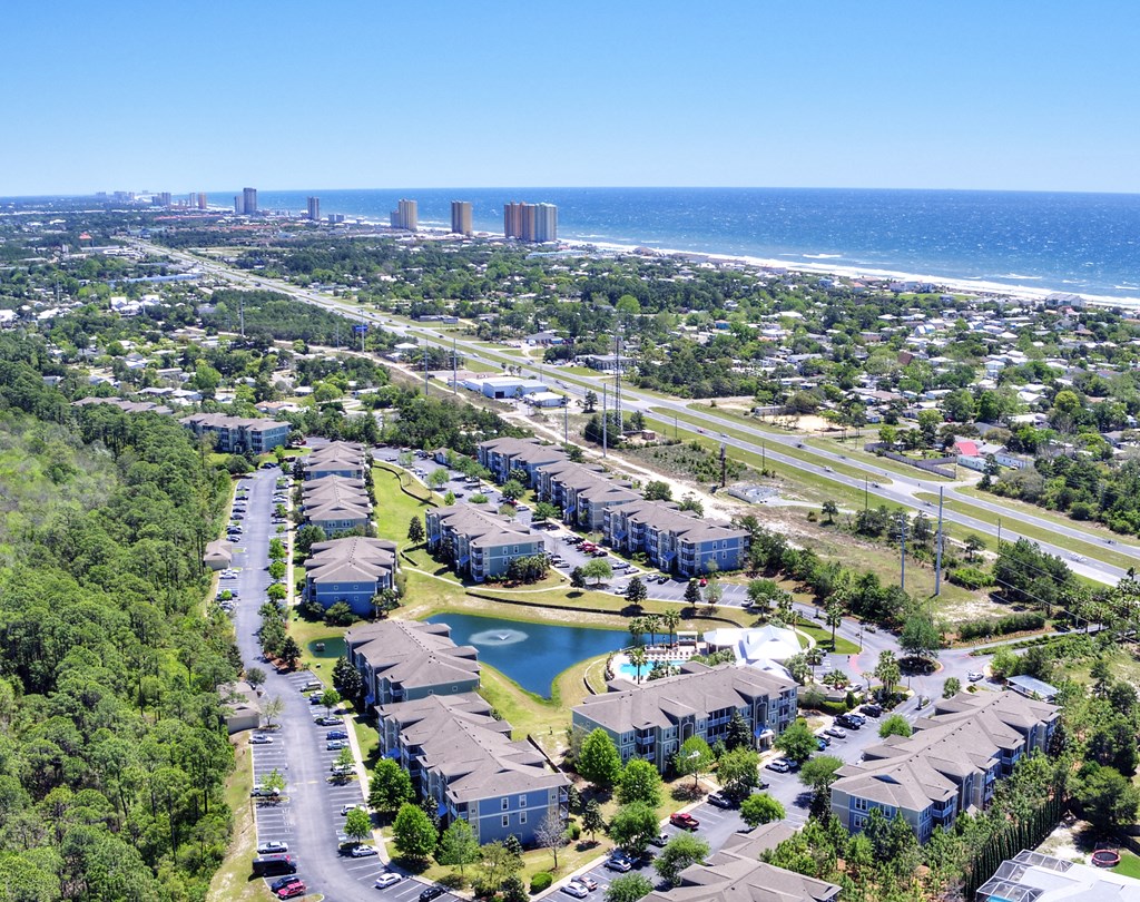 A bird's eye view of a residential area with a road running through it.