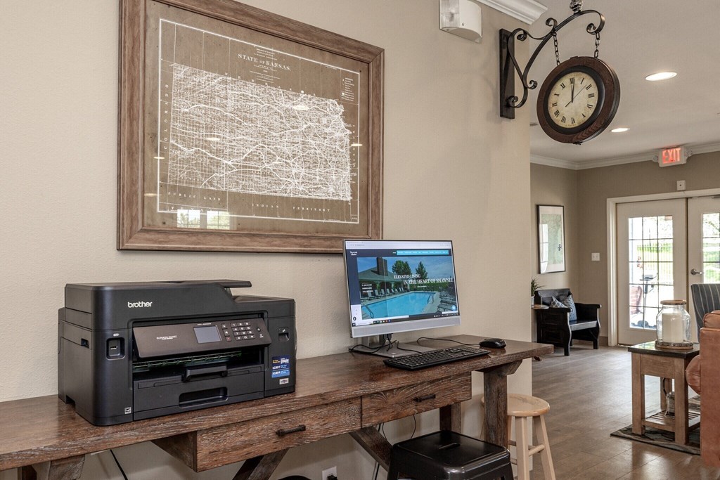 a home office with a computer and a printer on a desk