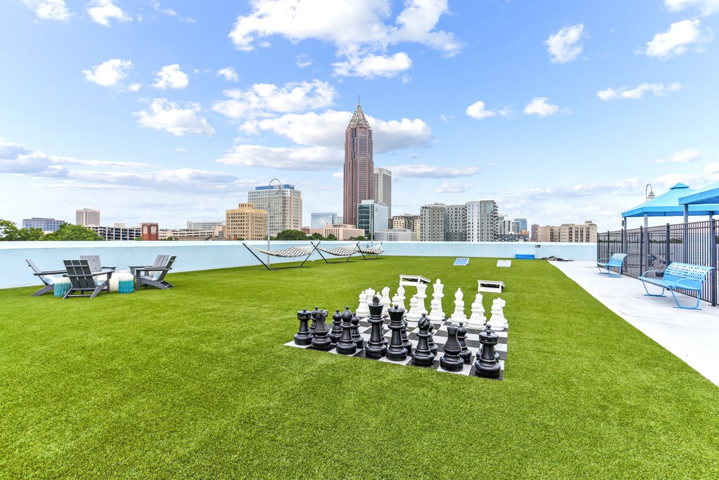 A giant chess set is set up on a lawn.