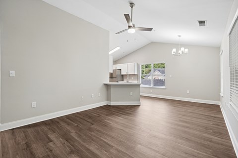 A room with a ceiling fan and light fixture.