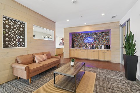 A living room with a brown couch and a coffee table.