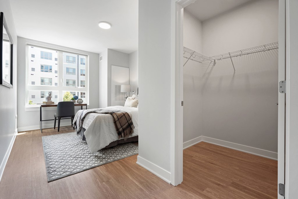a bedroom with a bed and a window in a 555 waverly unit