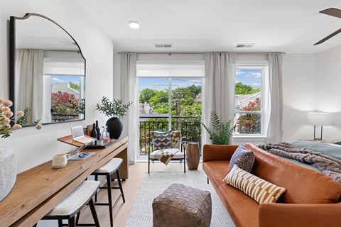 A modern living room with a large window overlooking a garden.