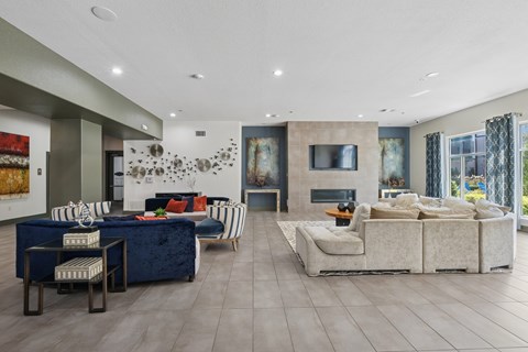 A modern living room with a blue sofa and a white couch.