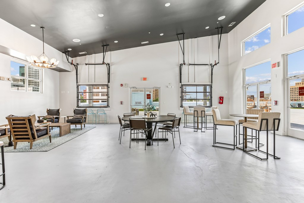A large open space with a dining table and chairs.
