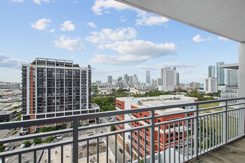 a view of the city from the balcony of a condo