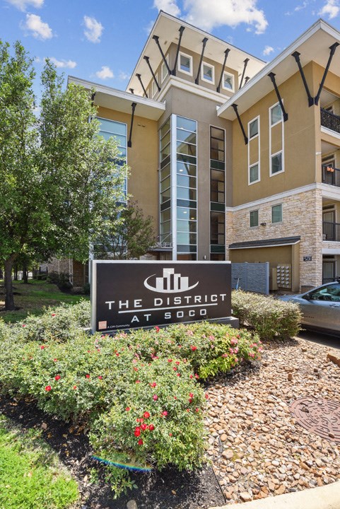 a sign for the district at 505 in front of a building