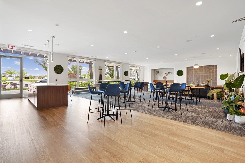 a large room with a bar and chairs