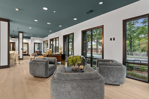 A modern living room with grey couches and a wooden coffee table.