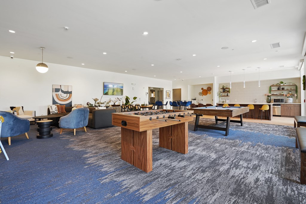 a games room with a foosball table and ping pong table