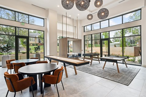 A modern dining room with a round table and chairs.