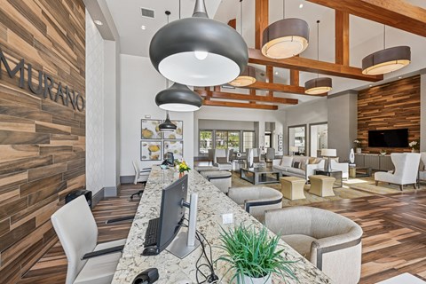 A modern office space with a reception desk and comfortable seating areas.